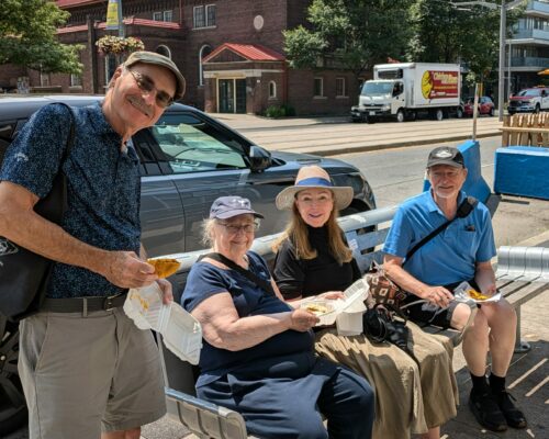 A group of tourists enjoying yummy pastries along the food tour