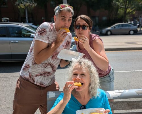Tourist enjoying some patties during the food tour