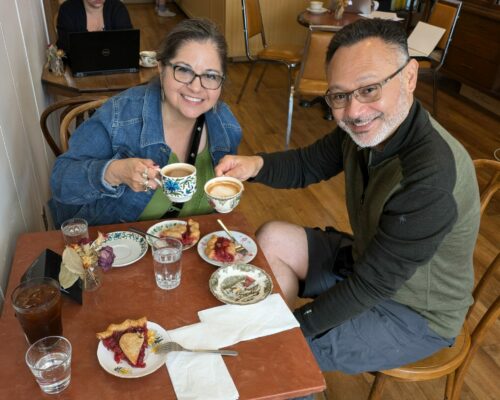 A couple enjoying coffee and some dessert